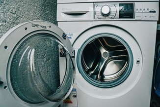 A front-load washer with the door open in Oklahoma City
