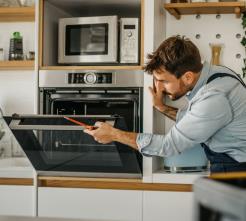 a technician studying a broken oven