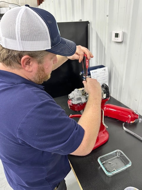 An Adam's technician repairing a Kitchenaid mixer in Warr Acres