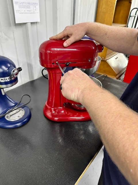An Adam's technician repairing a KitchenAid mixer in Oklahoma City
